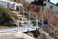 Platform lift in a residential neighborhood on a sloped site.