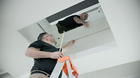 Installers from Garaventa Lift Germany prepare the ceiling opening for the Savaria Luma Homelift.